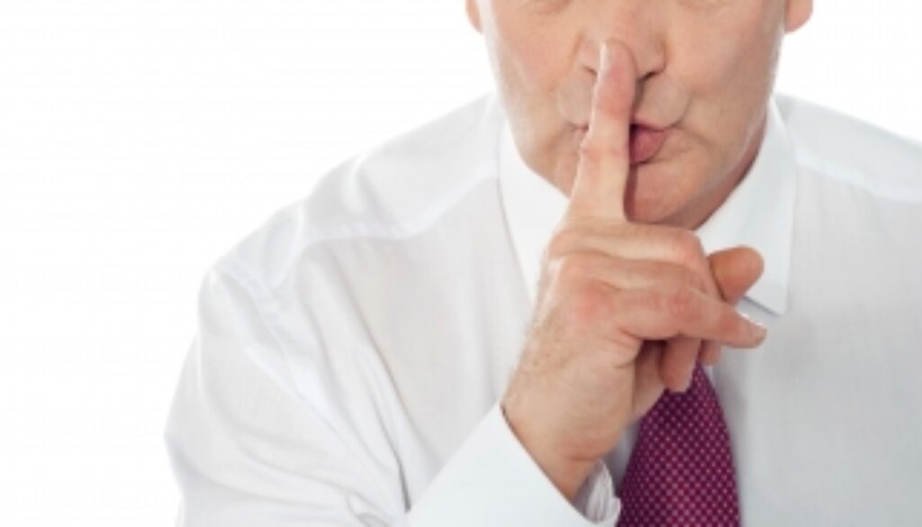 Businessman Showing Silence Gesture Stock Photo